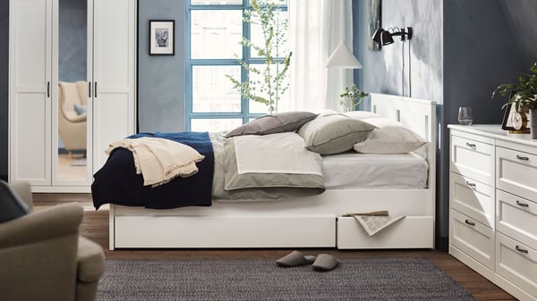 A white SONGESAND wardrobe in the bedroom