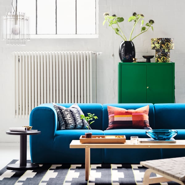 An off-white/black STOCKHOLM 2025 cushion cover in the living room