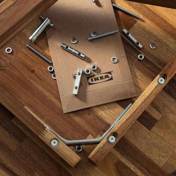 a chair frame surrounded by nuts and bolts