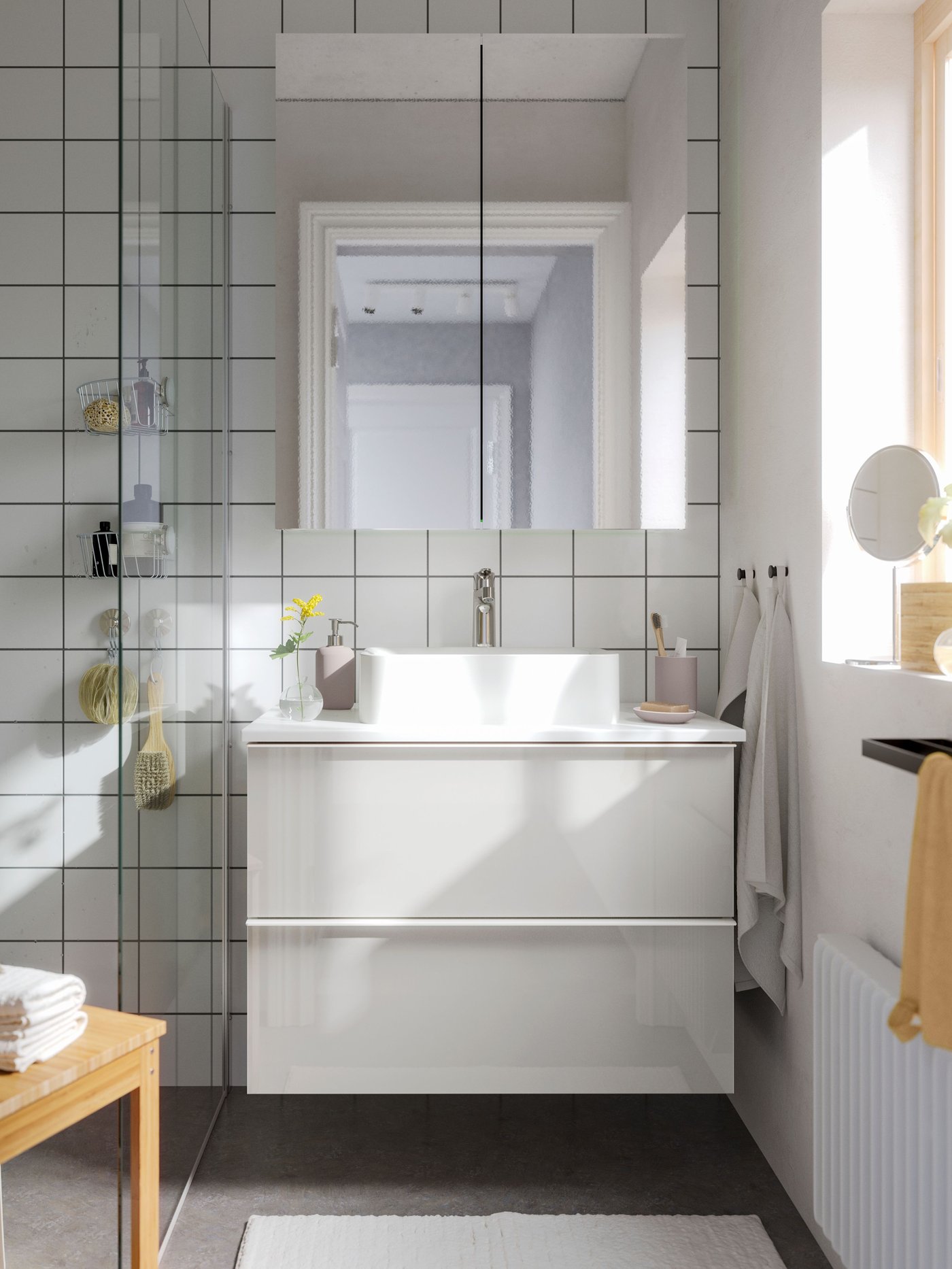 A bright bathroom with GODMORGON bathroom furniture, including a mirror cabinet with 2 doors, and a window.