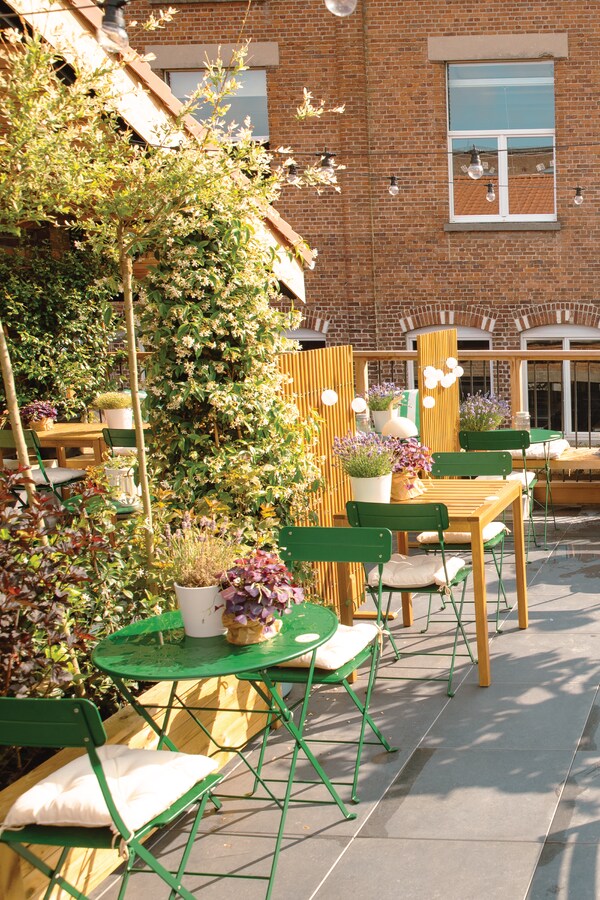 Terrasse restaurant avec des tables pour deux couleur verte.