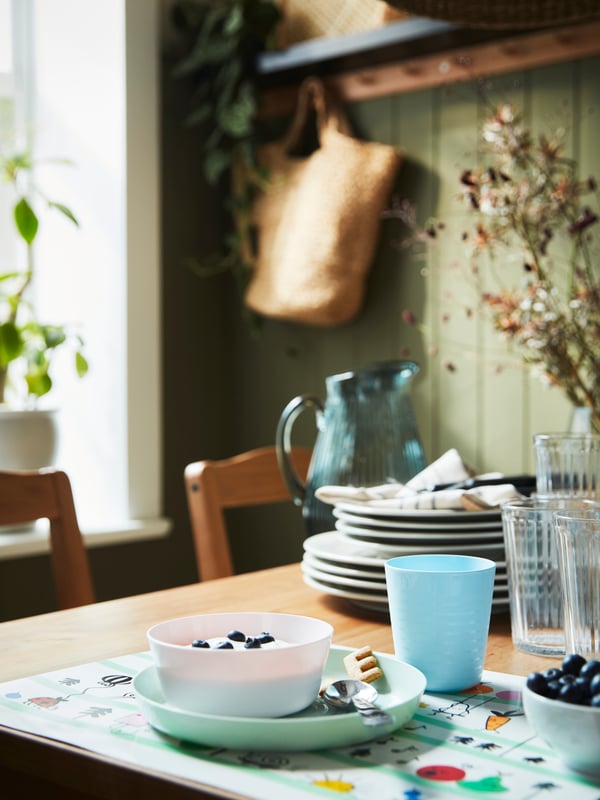 SANDSKÄDDA plates stand near KALAS tableware on top of a GRÖNFINK place mat on an antique stained pine HÄGERNÄS table.