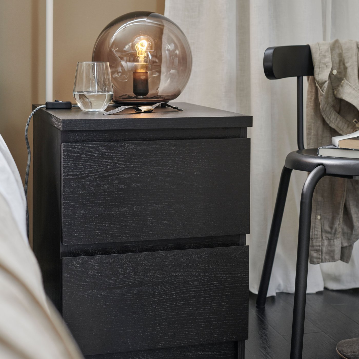 Una cassettiera MALM nero-marrone a due cassetti in camera da letto