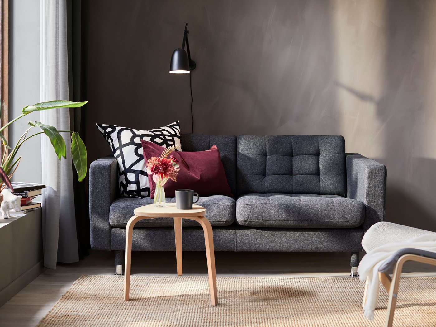 A black SKURUP work/wall lamp in the living room