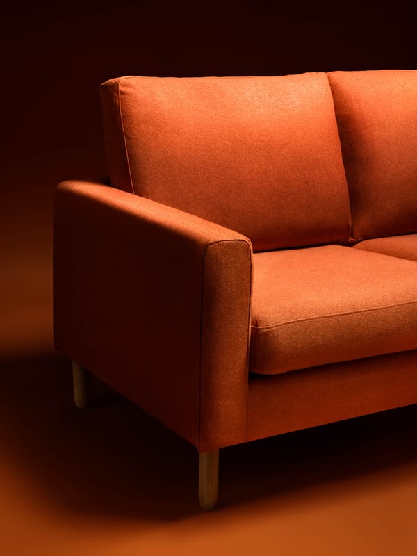 SALTSJÖBADEN red sofa on a dark red background.