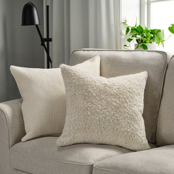 A beige NÄTNÄVA cushion cover