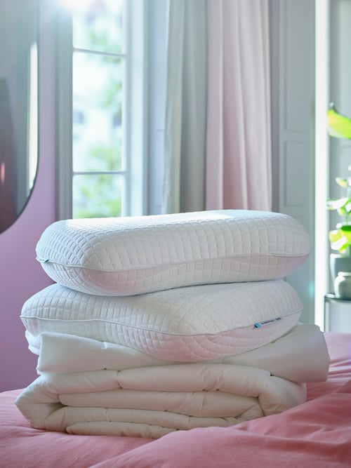 Two KLUBBSPORRE pillows on top of a SMÅSPORRE duvet, on top of a bed covered with ÄNGSLILJA bedlinen.