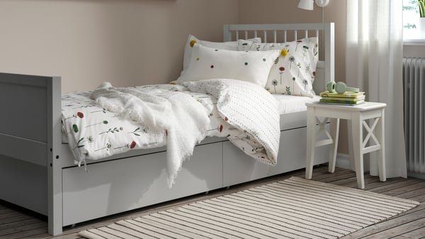 A light grey SMYGA bed storage box