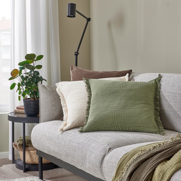 A grey-green VALLKRASSING cushion cover