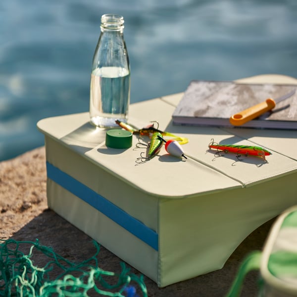 A pale green STRANDĂ–N tray table, in/outdoor