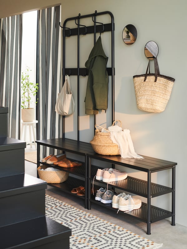A black PINNIG coat rack with shoe storage bench