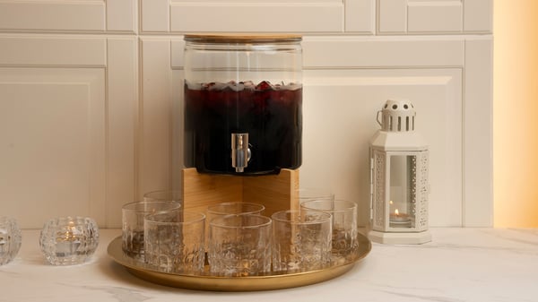 A bamboo ÖGONTRÖST stand for jar with tap