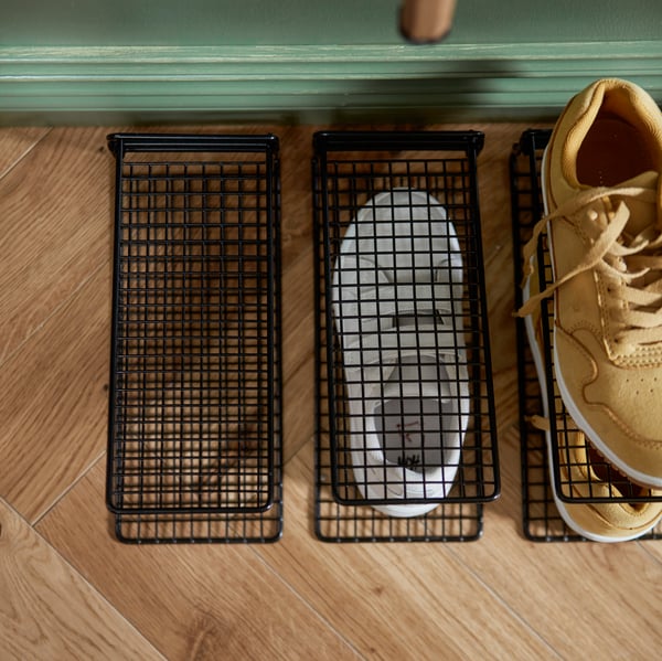 SKOSTALL maximising space in the hallway with 2 pairs of shoes vertically organised on top of one another.