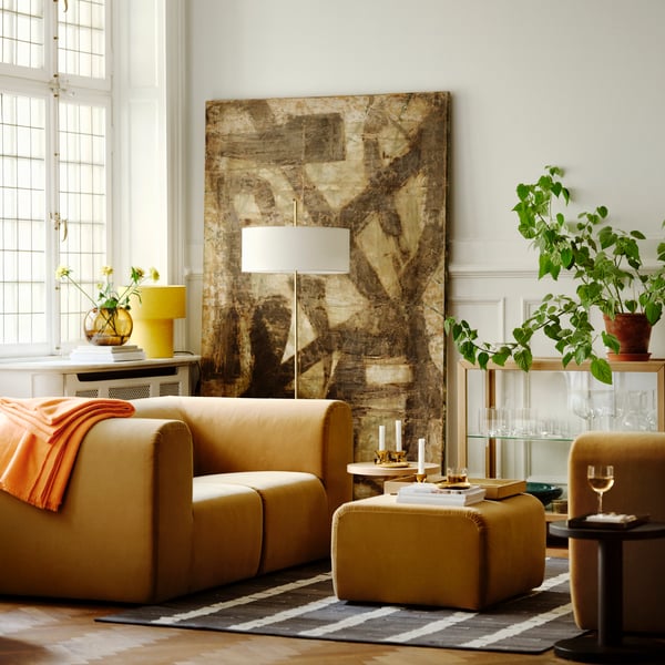 A brass-colour STOCKHOLM 2025 candlestick/tealight holder in the living room