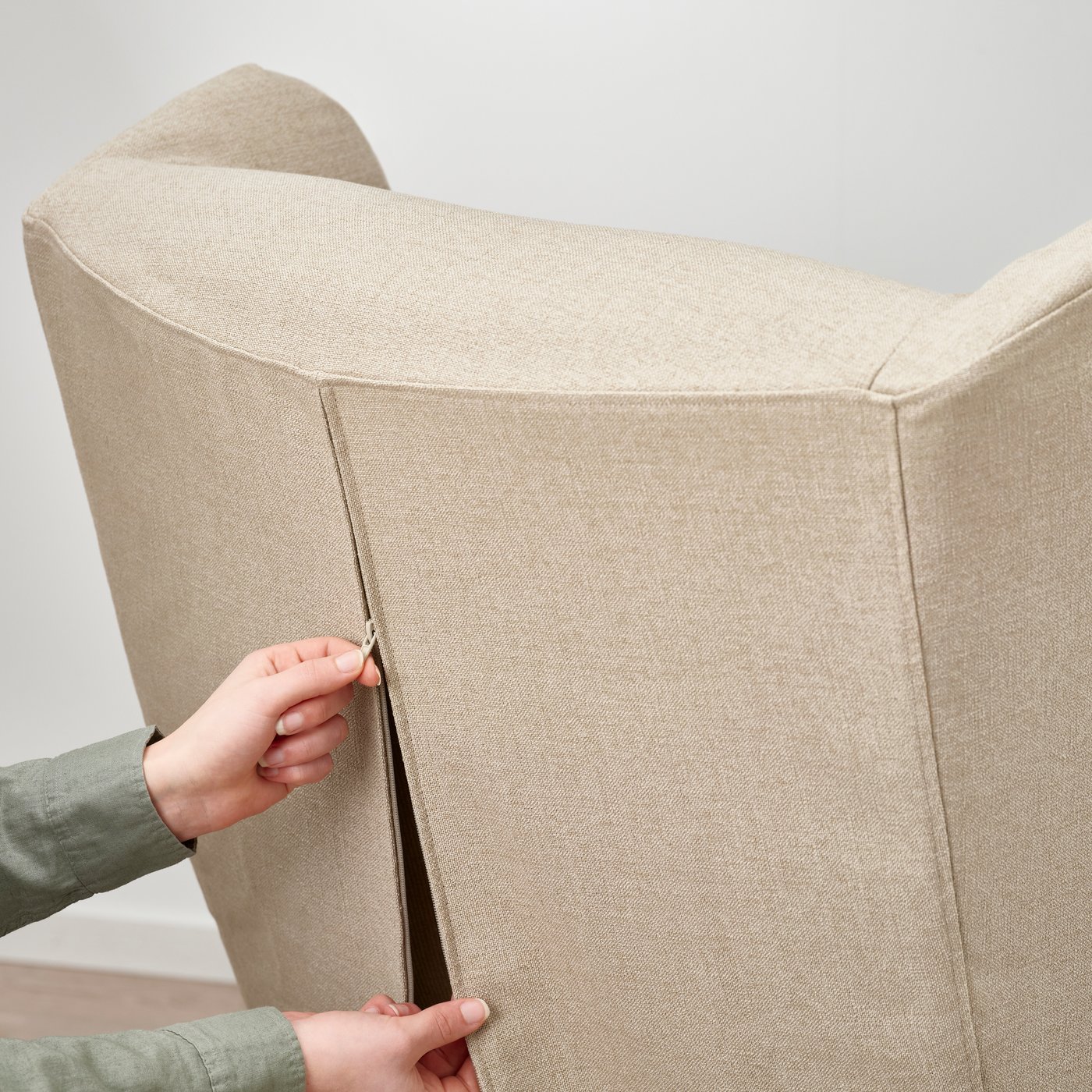 A beige STRANDMON Slipcover for wing chair