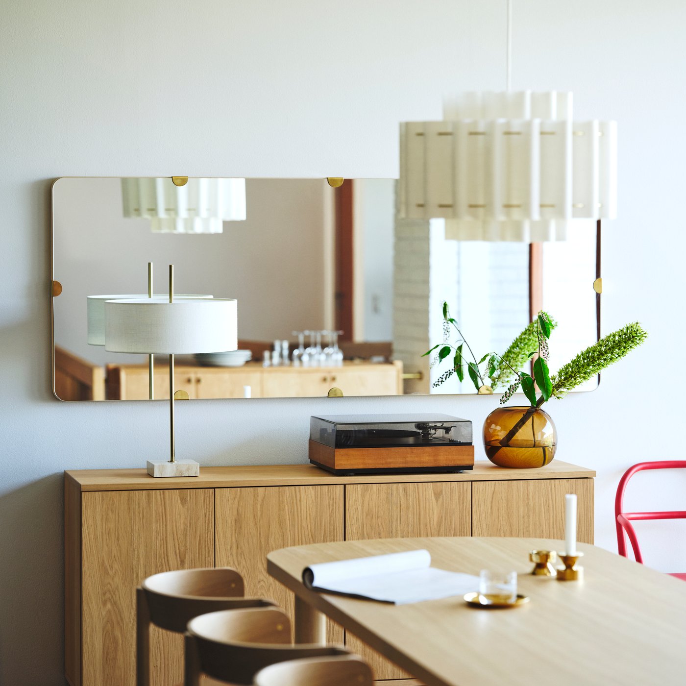 A white JUBLA unscented chandelier candle in the dining room