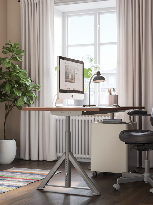 A brown/dark grey IDÅSEN desk.