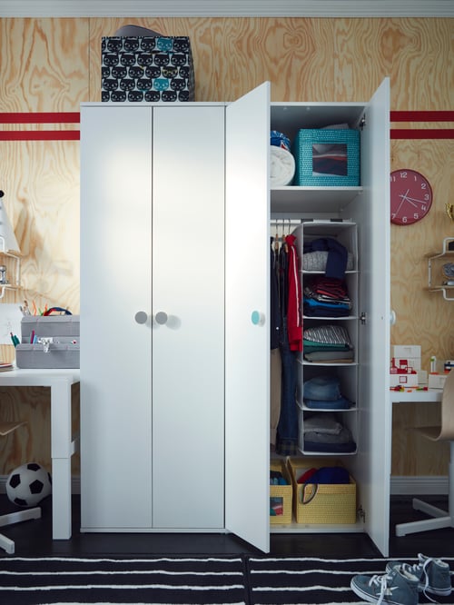 Two GODISHUS wardrobes between two desks. One is open showing clothes on a hanging rail and hanging shelves and in boxes.