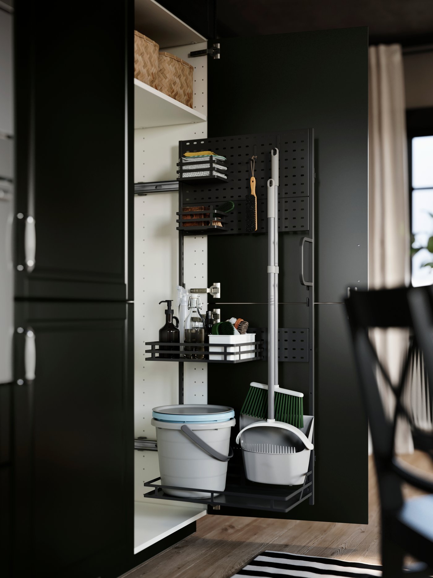 A kitchen cabinet has an open door with an UTRUSTA cleaning interior, with adjustable wire shelves with cleaning supplies.