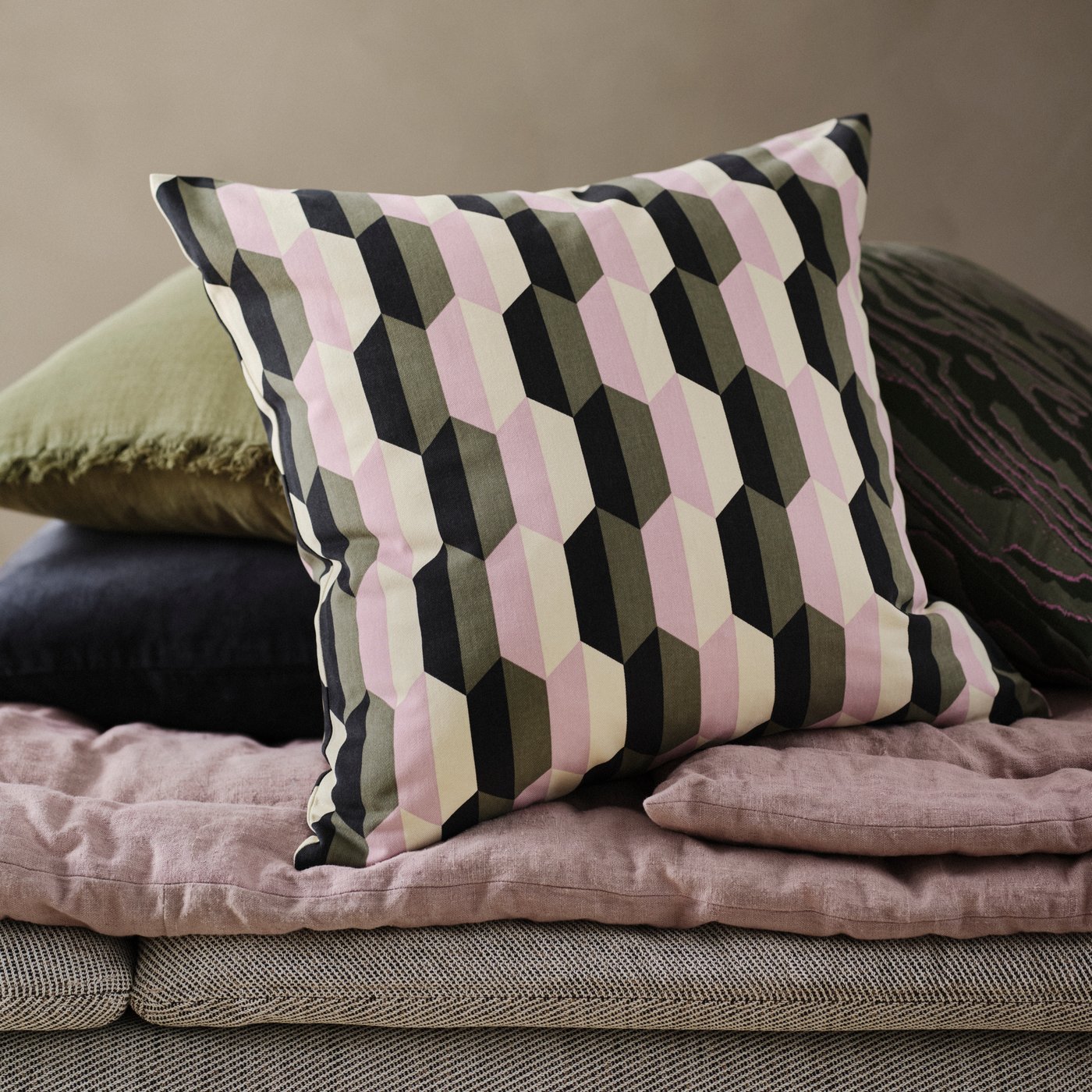 Sarung kusyen BÅTSPINNARE bersandar pada sarung kusyen TANDMOTT, SANELA dan VALLKRASSING di atas chaise longue SÖDERHAMN.