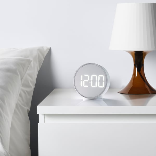 A white PLUGGET alarm clock
