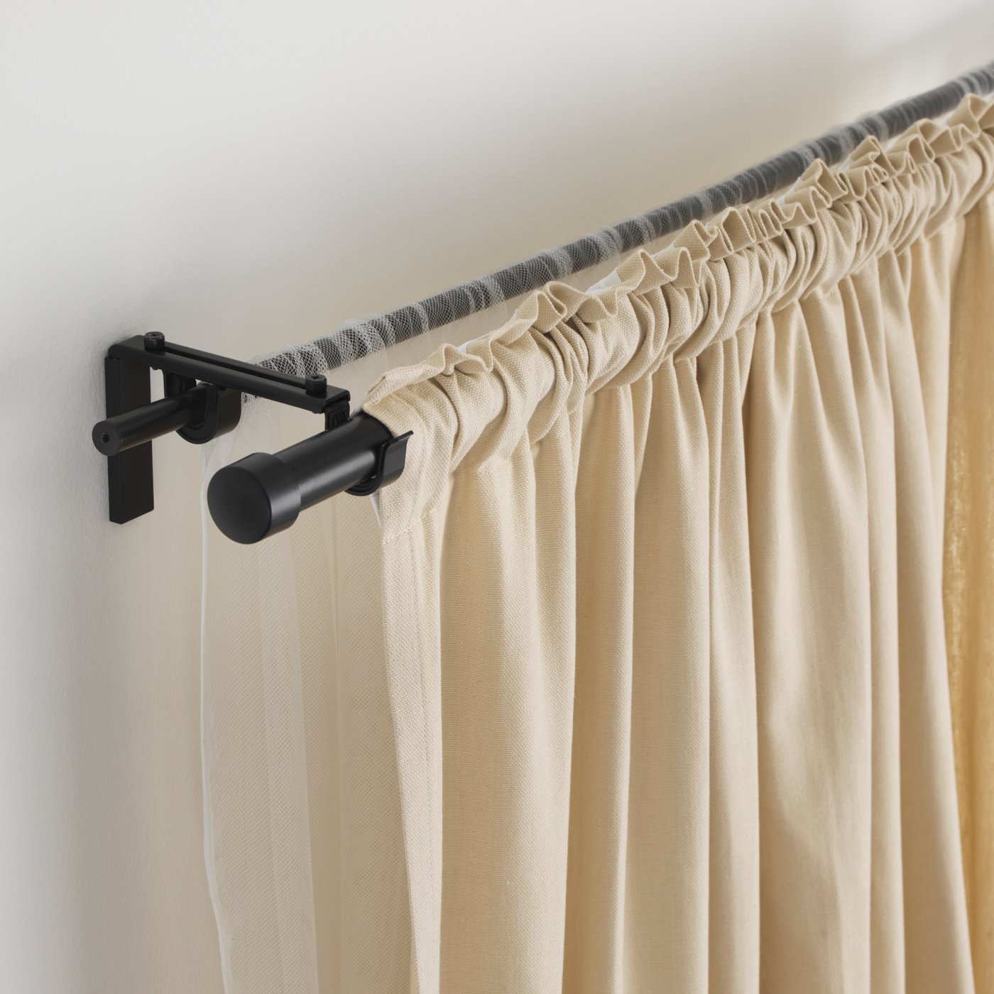 A black HUGAD double curtain rod combination
