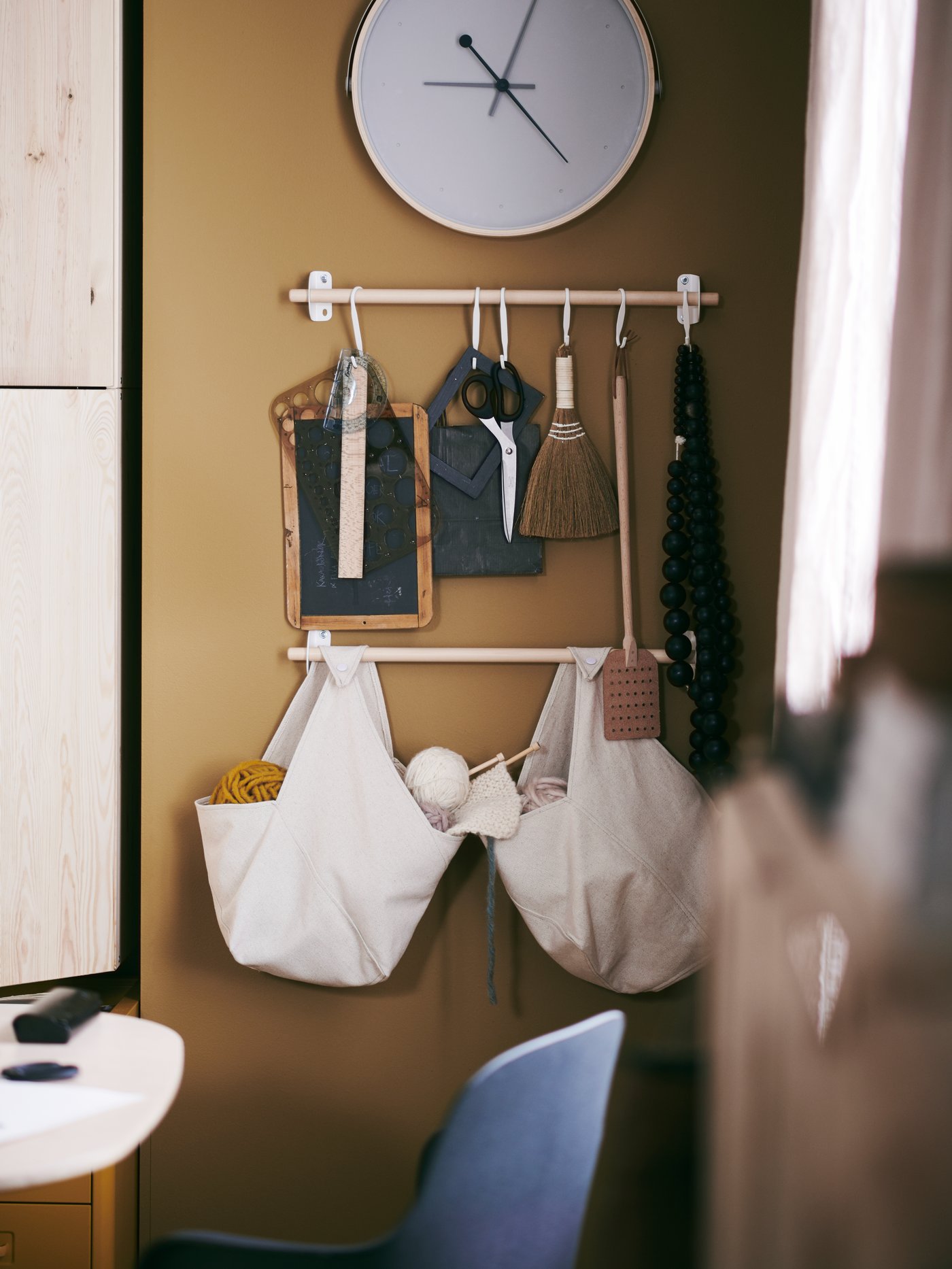 An assortment of products from the NEREBY series creates wall-mounted storage for stationery and craft supplies.
