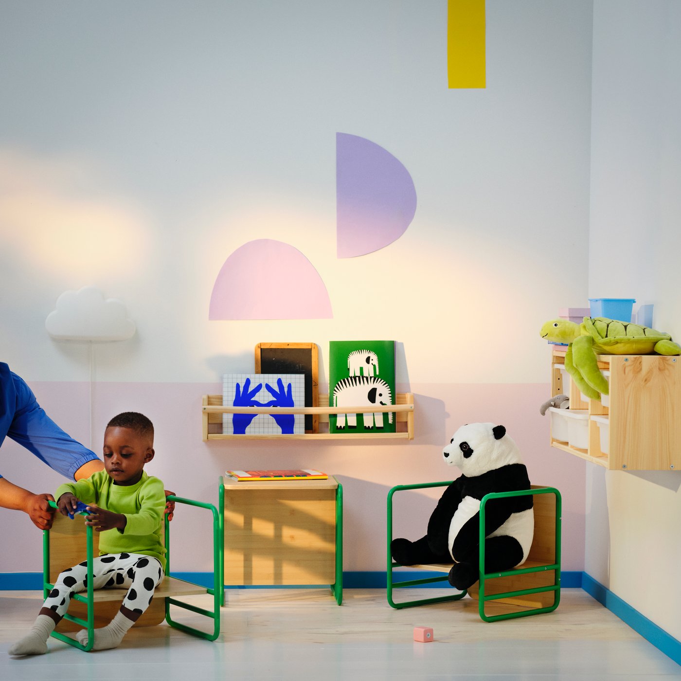A green SMÅSKRAKE multi-functional child chair/table in the childrens room