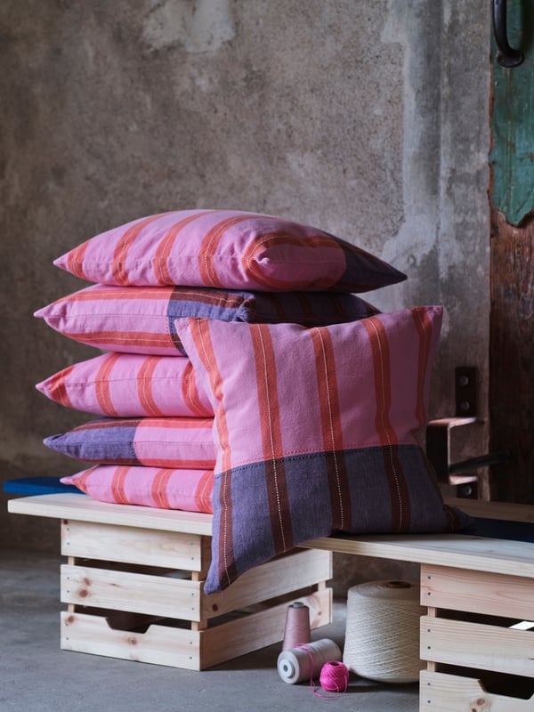A pink/orange MÄVINN cushion cover