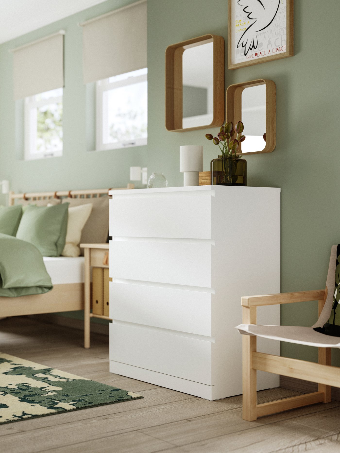 A white MALM chest of drawers stands in a bedroom.