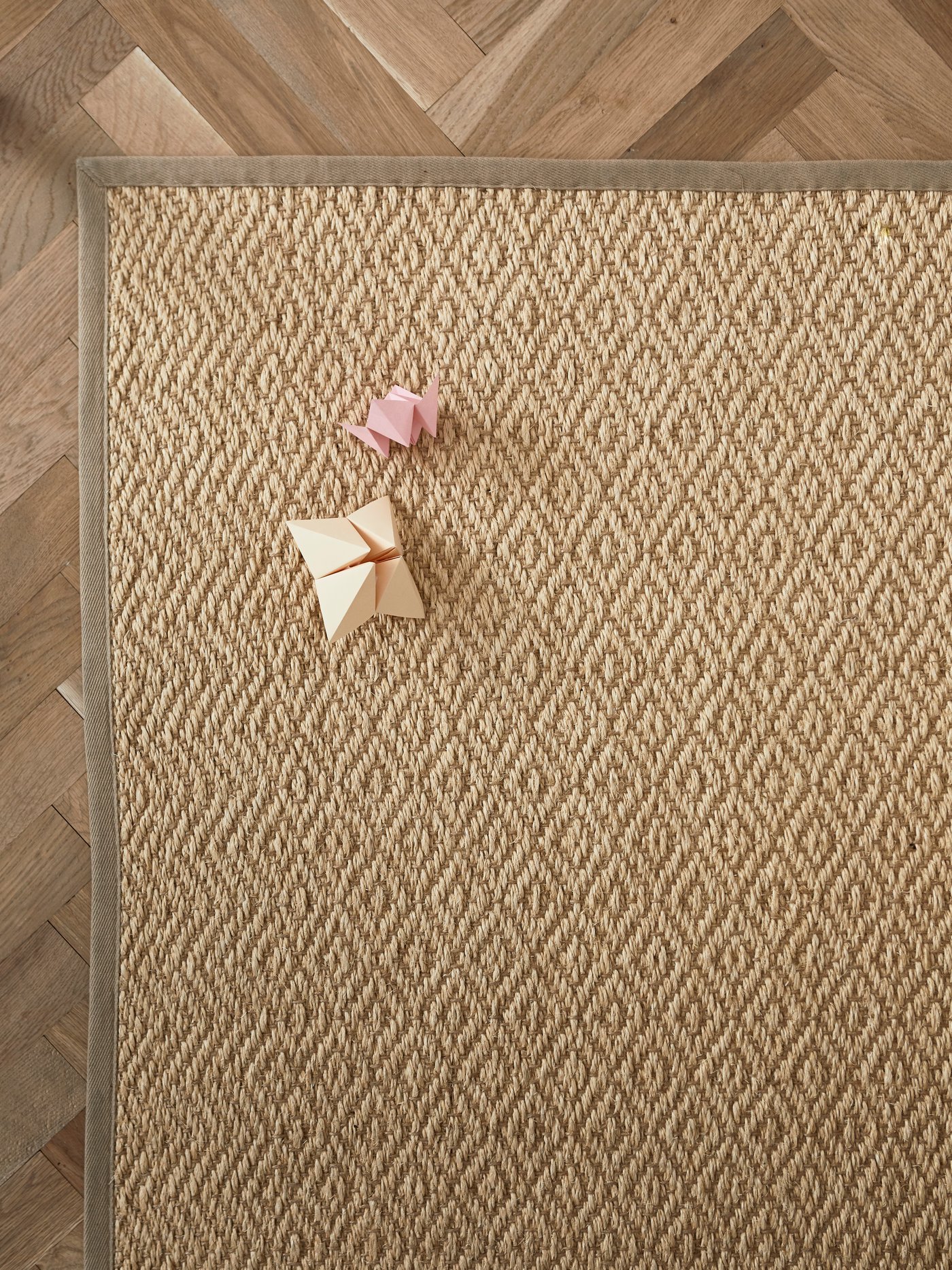 A flatwowen natural VISTOFT rug lays on a floor.