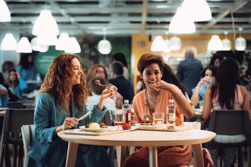 Zwei Frauen sitzen im IKEA Restaurant und essen