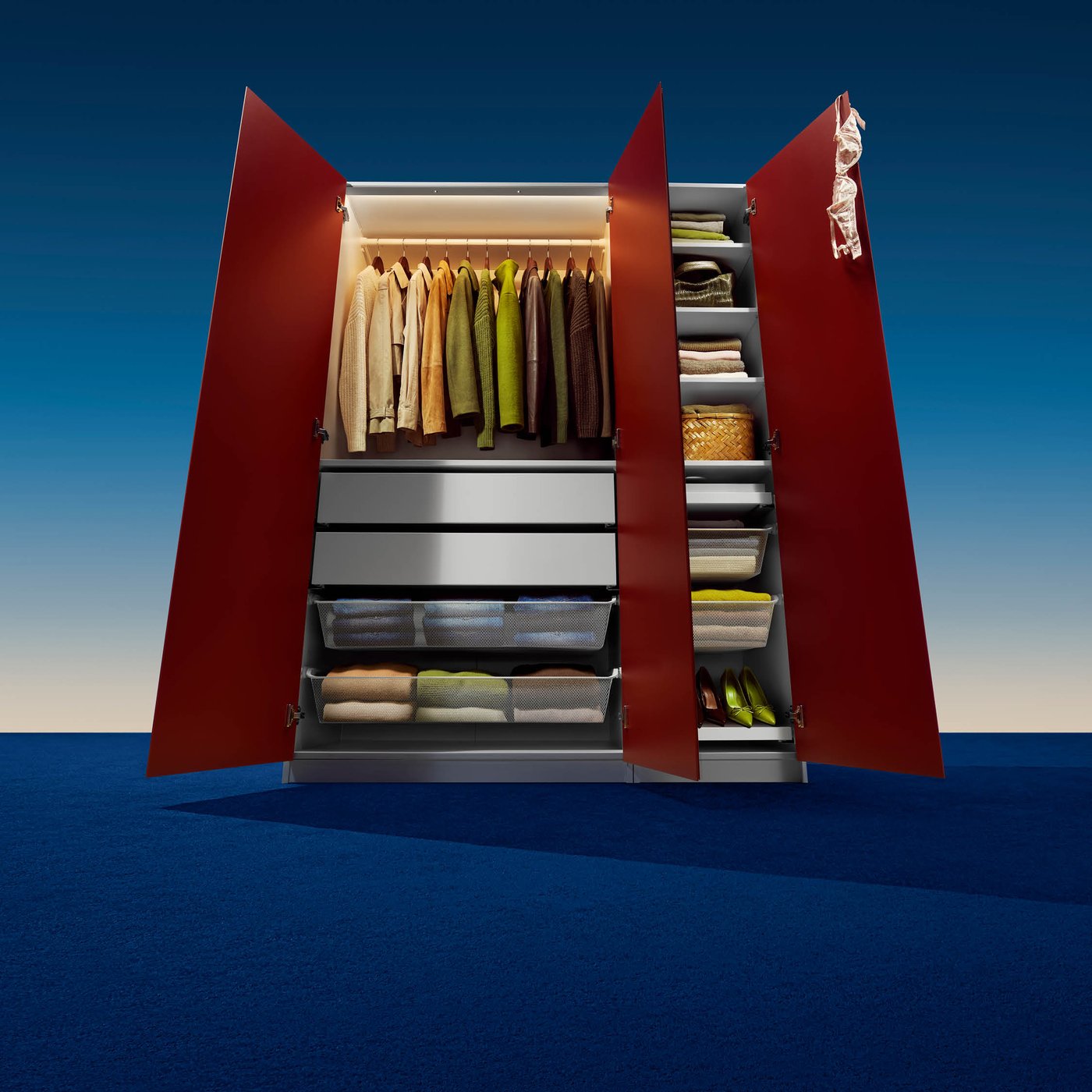 A full PAX wardrobe solution stood in studio lighting, the doors open, showing off the organised interior.