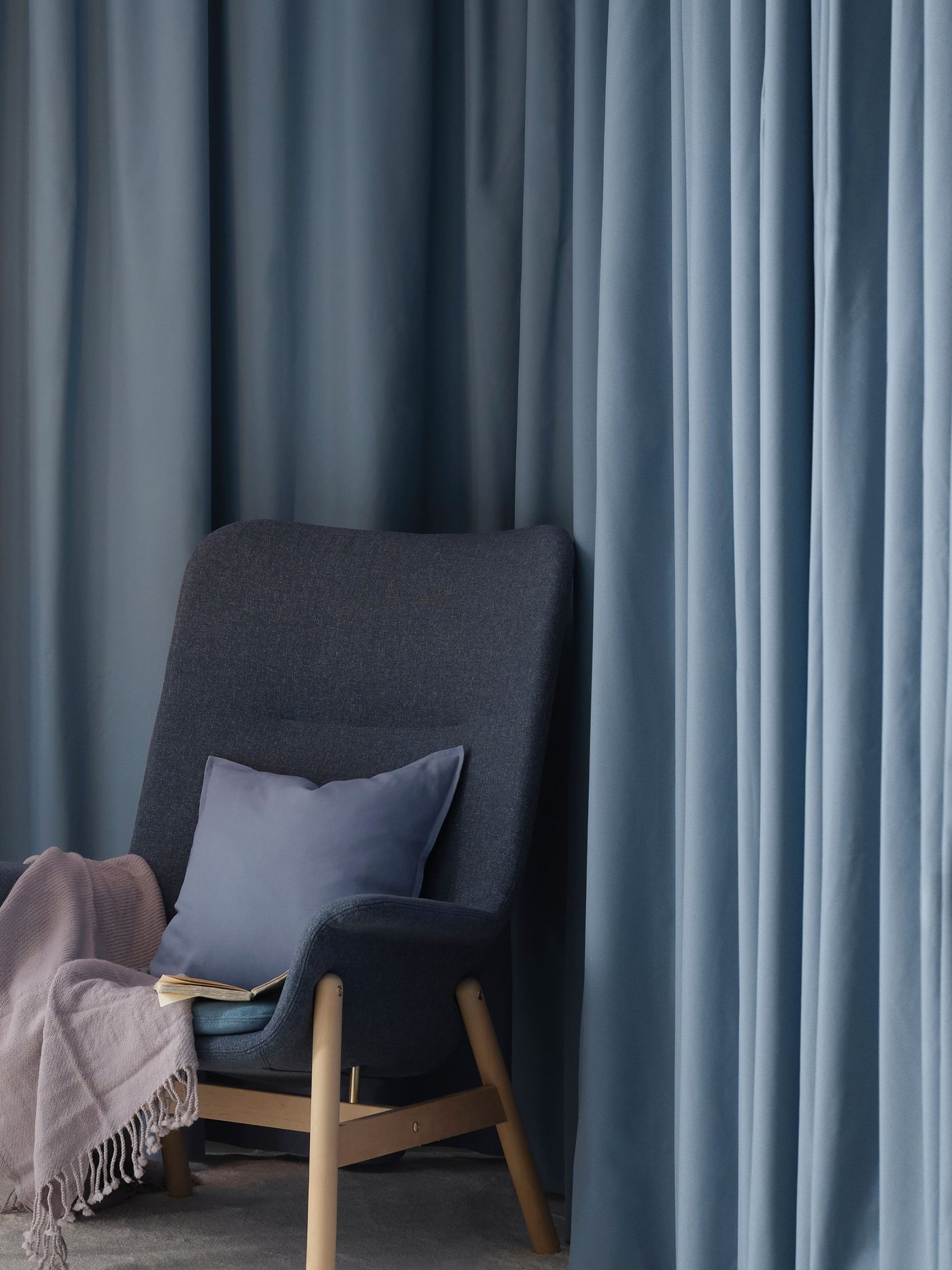 A Gunnared blue VEDBO high-back armchair in the bedroom