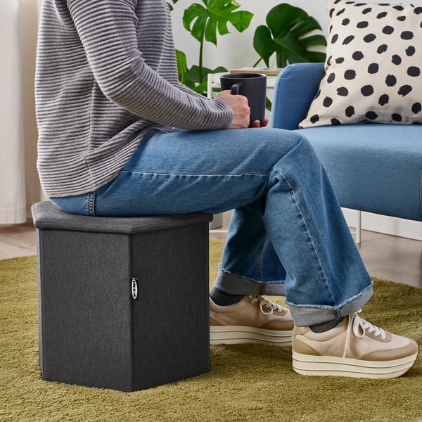 A Knisa dark grey KJUGE pouffe with storage