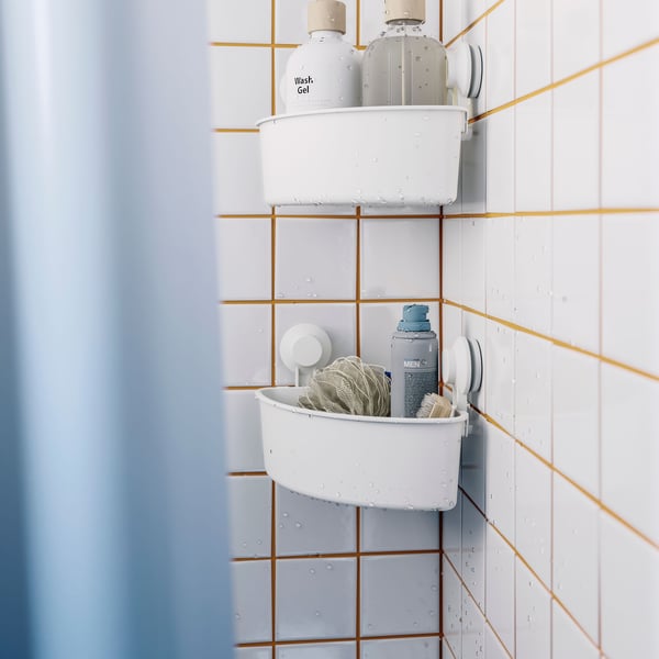 A white TISKEN corner shelf unit with suction cup in the bathroom