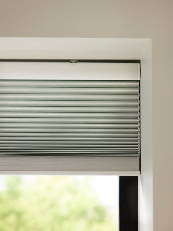 A smart wireless/battery-operated white TREDANSEN block-out cellular blind
