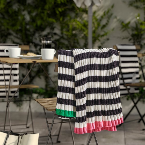 A black/white MOSSMOTT throw outside