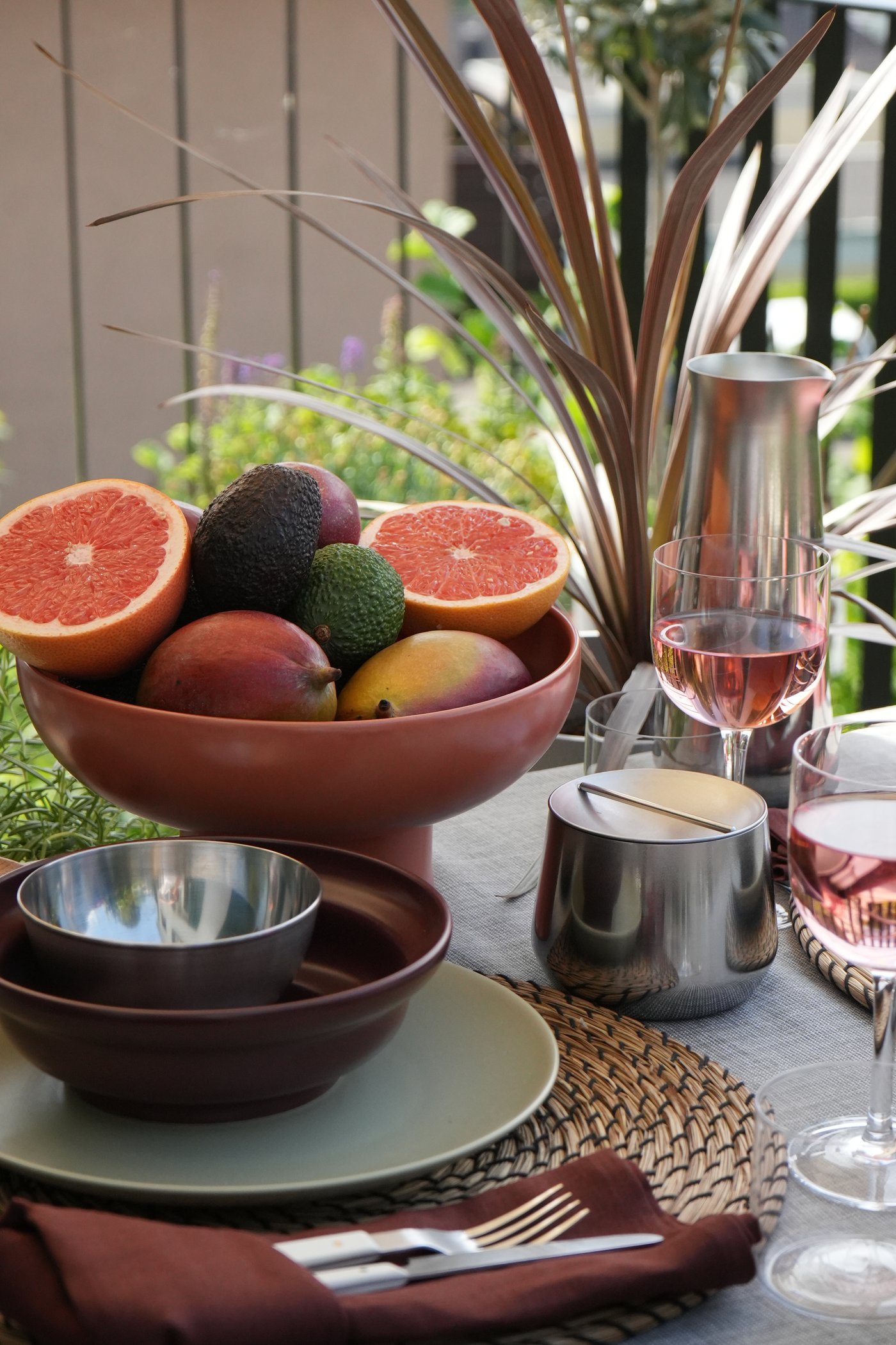 A red-brown BLOMVECKLARE serving bowl outside