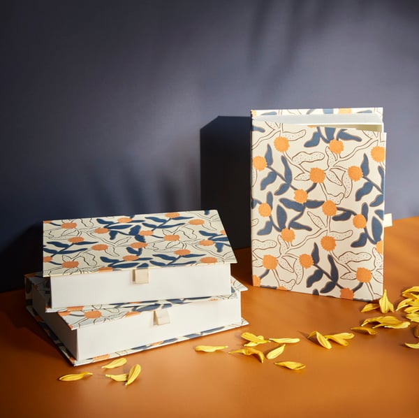 Decorative containers with a colorful leaf pattern.
