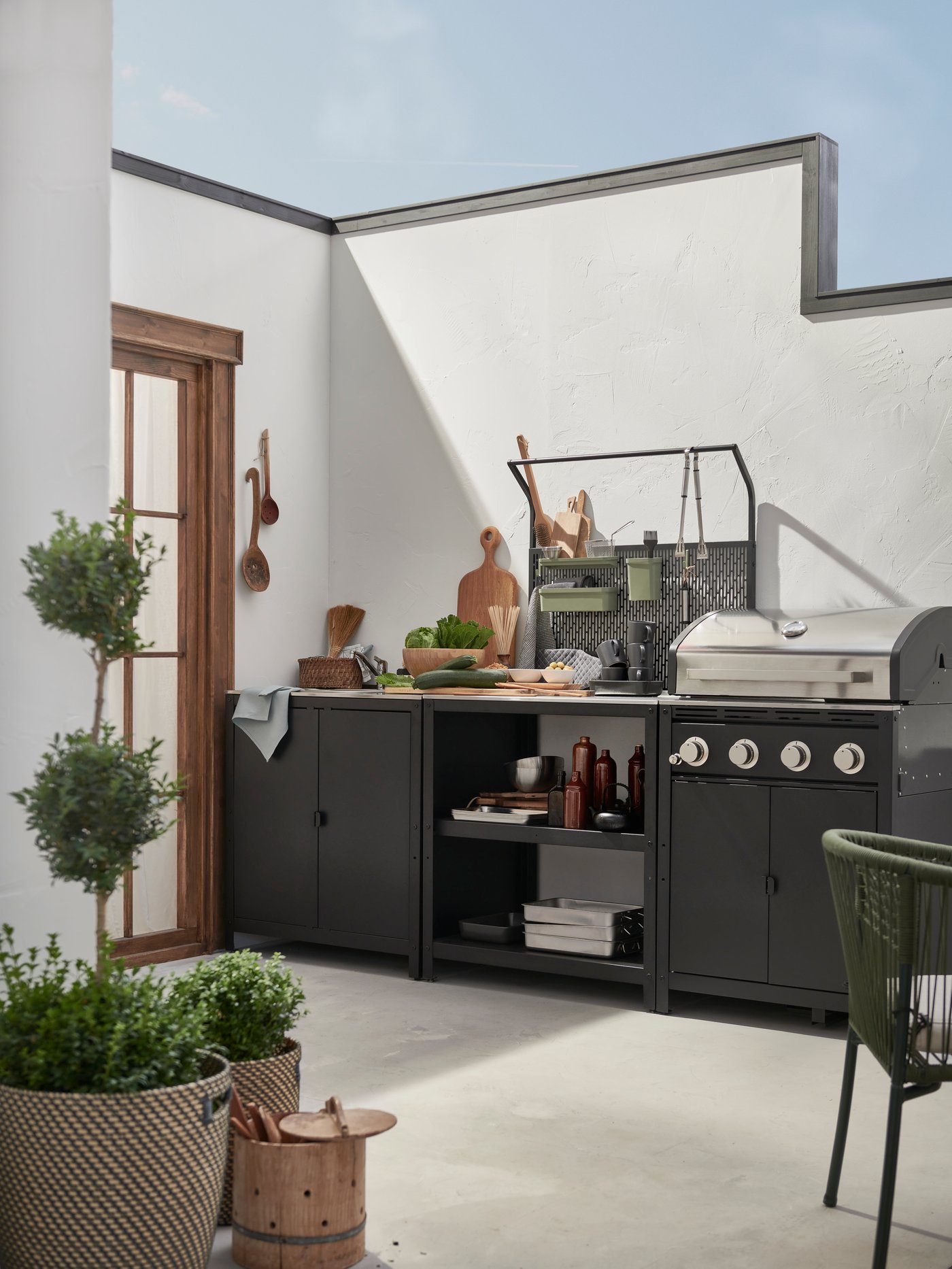 An outdoor kitchen from Ikea that stands on an outdoor porch.