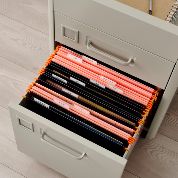 A beige IDÅSEN drawer unit on castors