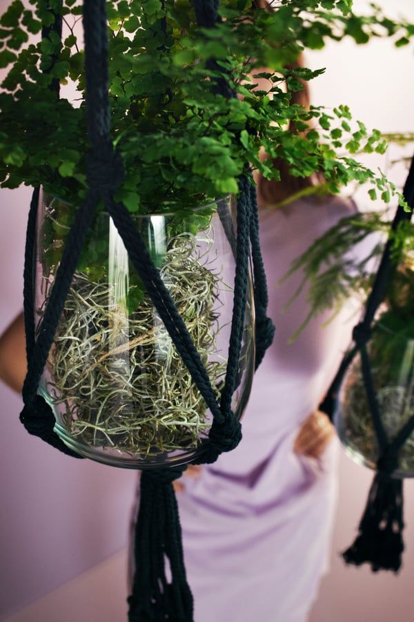 A black MÄVINN plant pot hanger