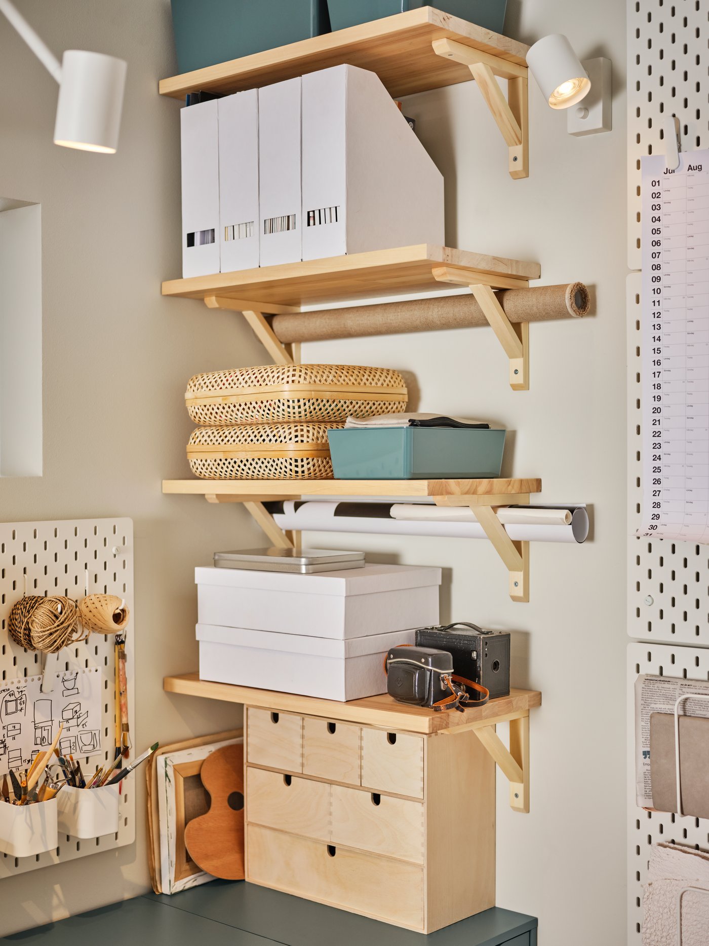 A turquoise KUGGIS storage box with lid in the home office