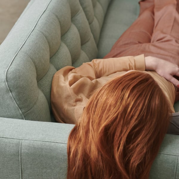A person laying down on a LANDSKRONA sofa