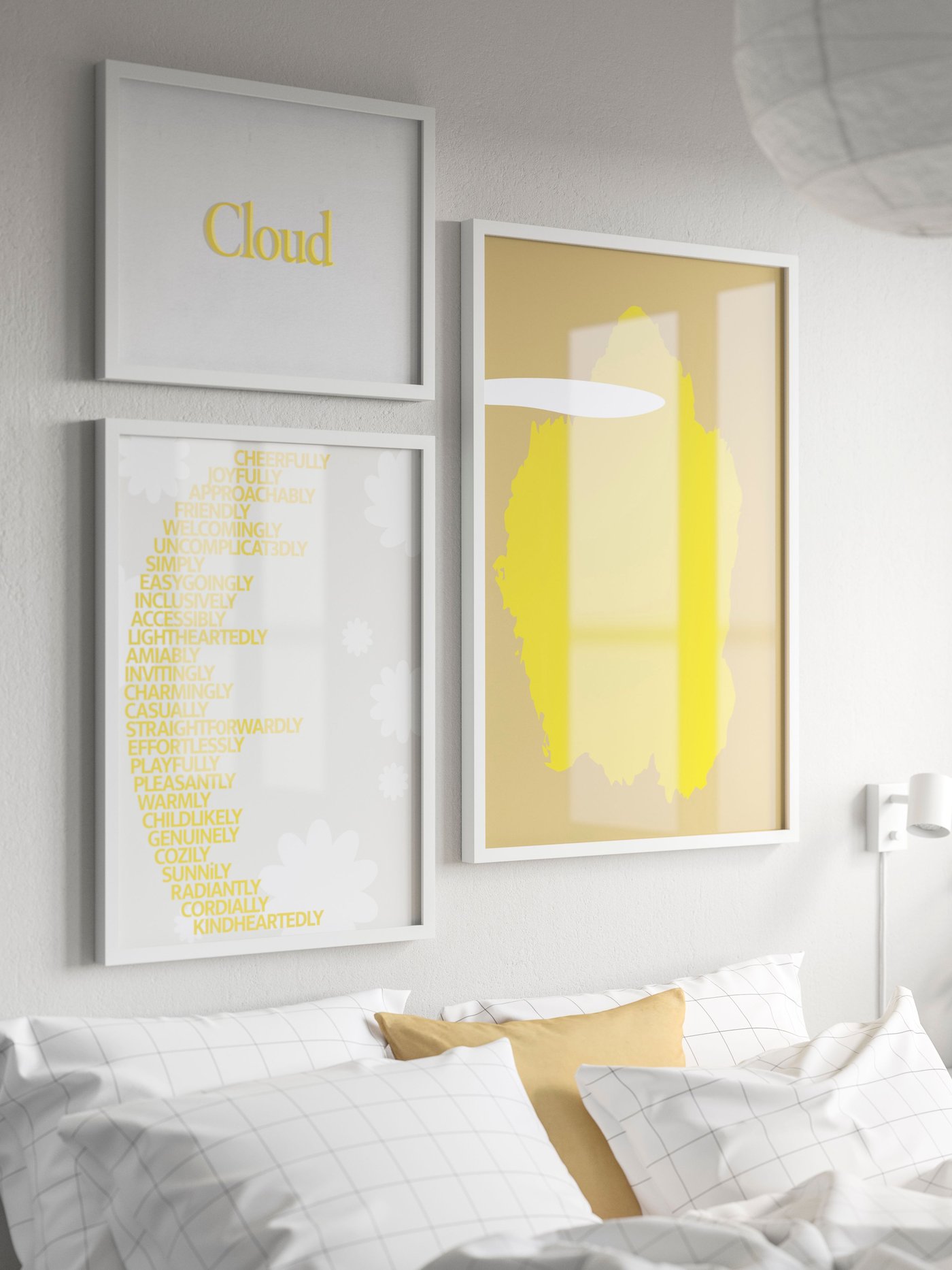 Three different sizes of RÖDALM photo frames hang above the bed on the wall, with a yellow poster inside.