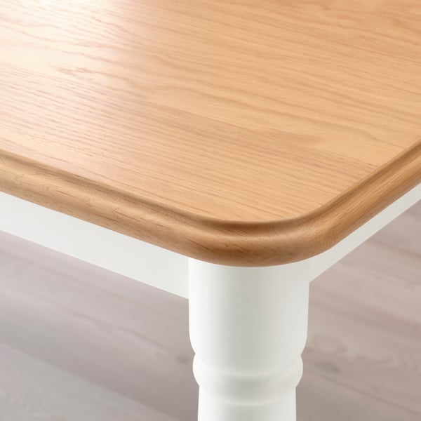 An oak veneer/white DANDERYD dining table in the NA