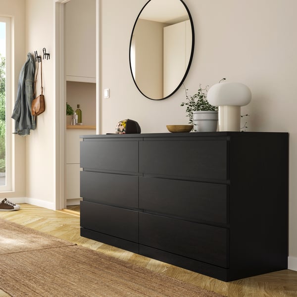 A black-brown MALM chest of 6 drawers in the hallway