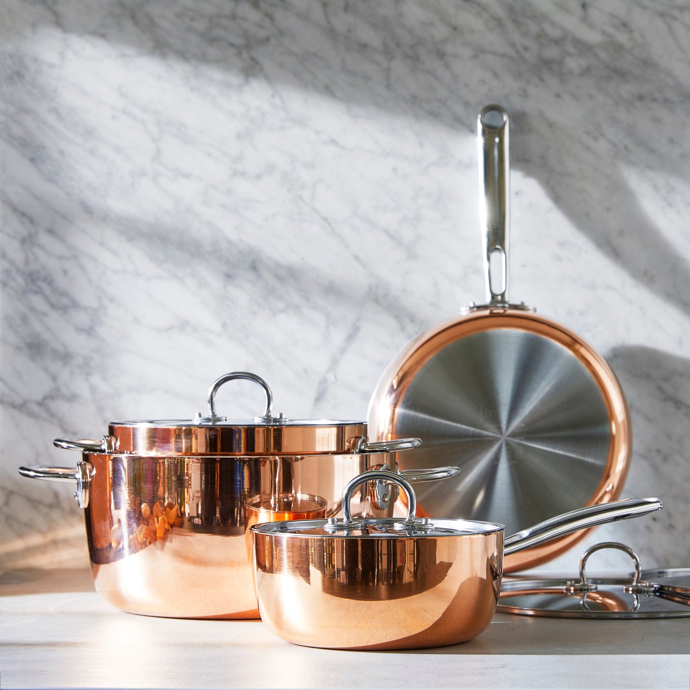 A copper/stainless steel FINMAT saucepan with lid in the NA