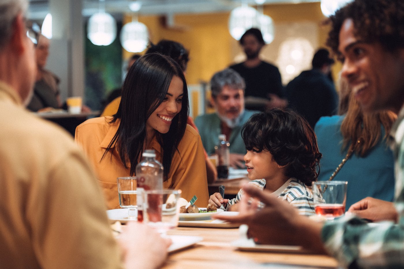 A family sitting in an IKEA Swedish Restaurant, enjoying a meal.